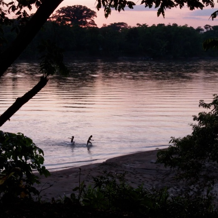 Siona people in the river at dusk